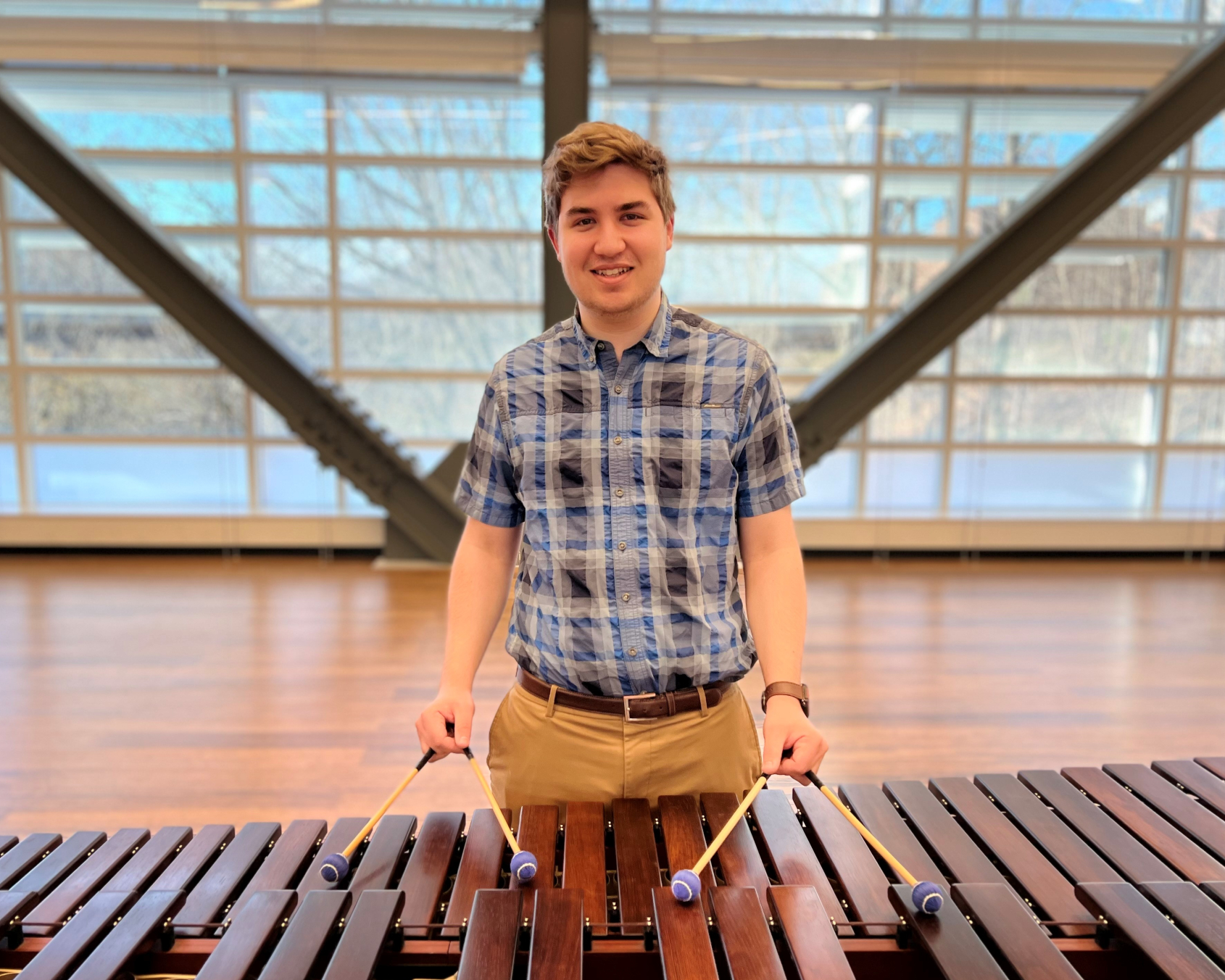 Brandon Phelps is in the Music degree program and an RA in the residence hall. He's pictured playing the marimba in the Academic II building.
