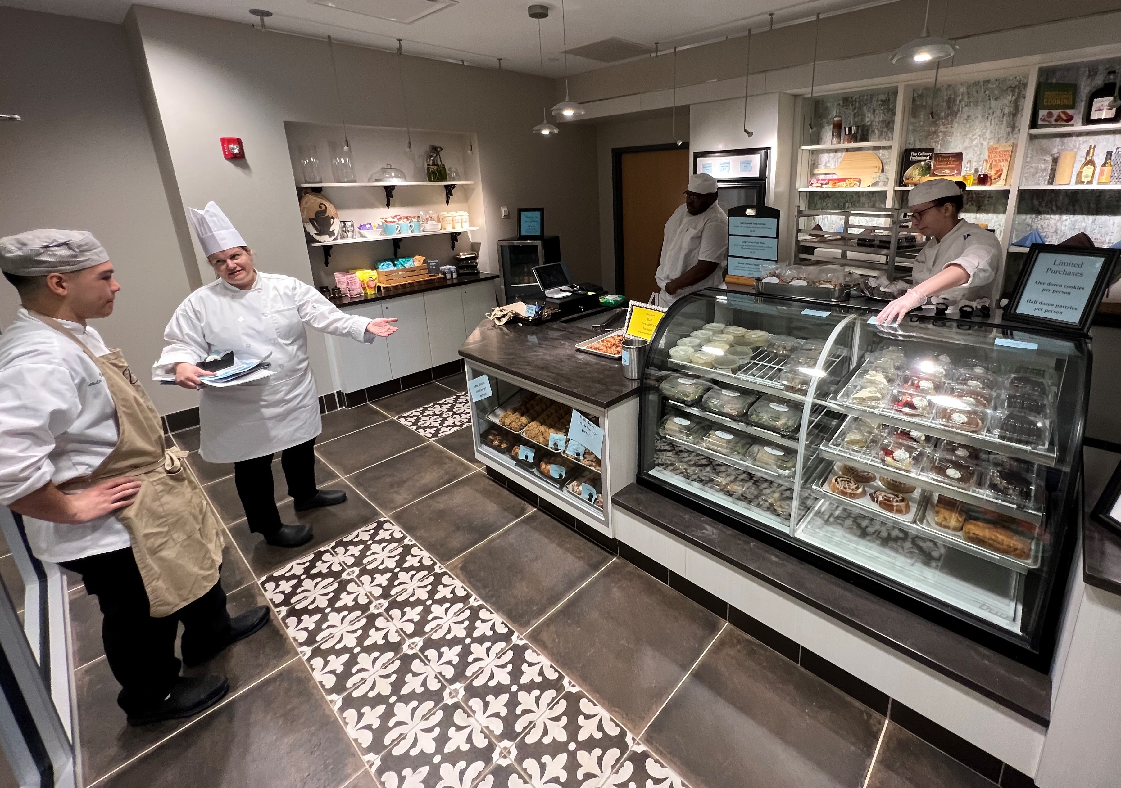 Chef Jeanne Catalfano reviews some last minute items with students before Bechamel opens for business. Th student-run retail store is open every Tuesday from 10:30 a.m. to noon.