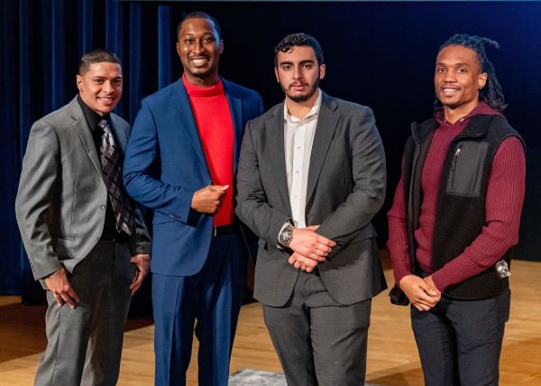 New County Legislator Maurice Brown (wearing red turtleneck) is pictured with (left to right) event emcee Shayne Turo '23, current OCC student Muhammed Abedrabbah, and Noah Rivers '23.