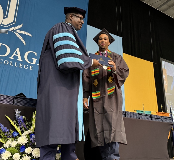 Reid (right) receives his degree from OCC President Dr. Warren Hilton (left) at Commencement.