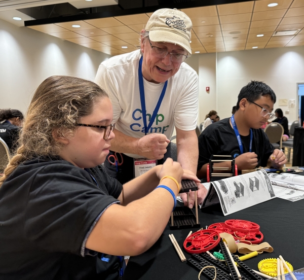 Professor Fred Jaquin worked with students building rubber rand racers at OCC's Micron-sponsored Chip Camp.