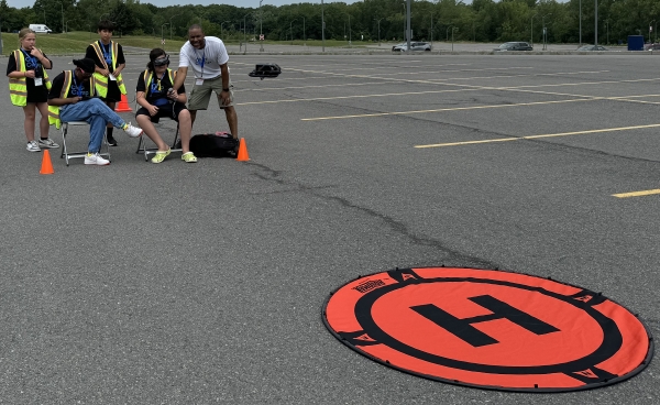 OCC Alumnus and PSLA at Fowler Teacher Quindell Williams helped students pilot a drone during Micron-sponsored Chip Camp.