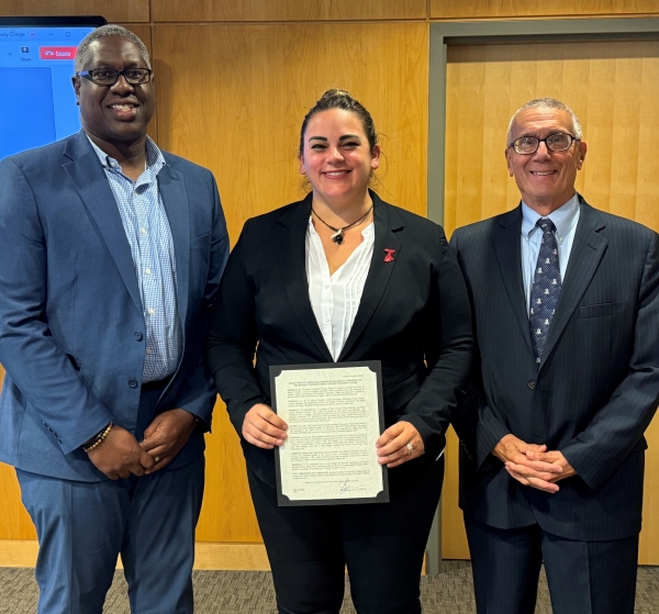 Heather Drake-Bianchi (center) received the John H. Mulroy Founder's Award from OCC President Dr. Warren Hilton (left) and Board Chair John Sindoni (right).