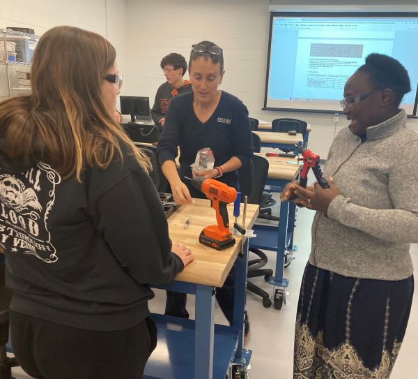 Professor Colleen Stevens (center, facing camera) works with students in the Real Life Rosies program.