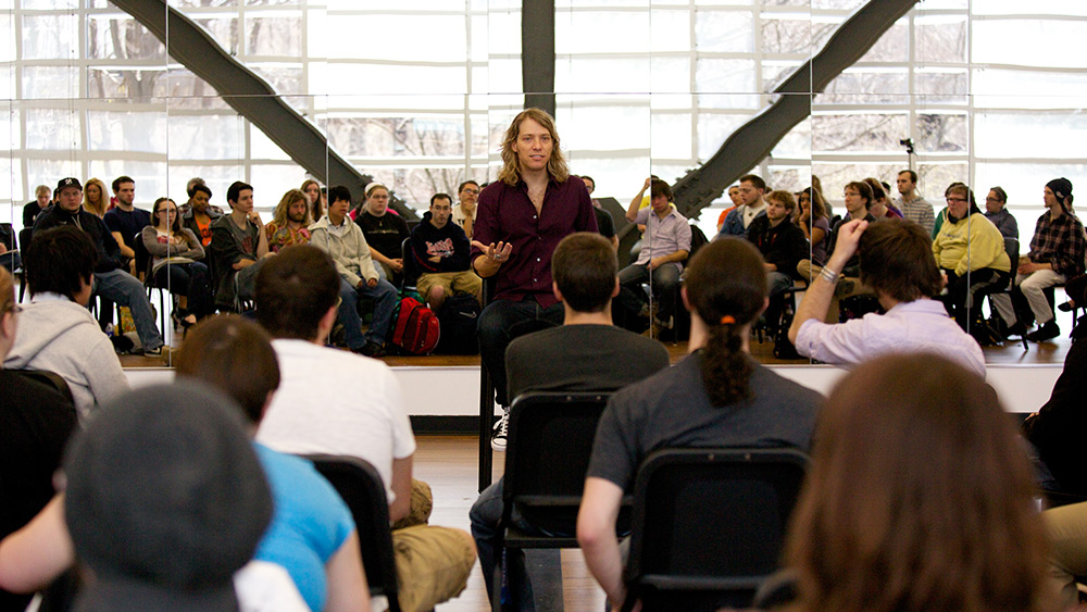 Mauro speaks with students in the instrument and choral rehearsal room in Academic II.
