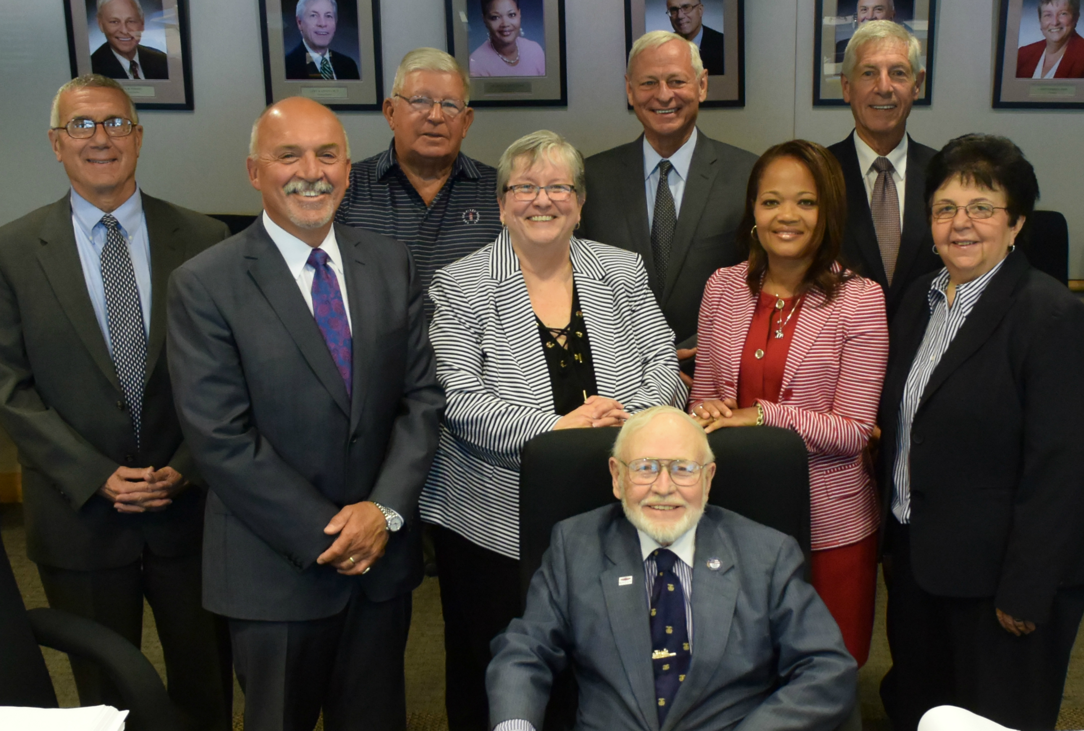 Donald Mawhinney (sitting) with OCC's Board of Trustees after their final meeting together. Behind Mawhinney are (left to right): John P. Sindoni, Esq., Allen J. Naples, Edward J. Heinrich, OCC President Dr. Casey Crabill, Neil Strodel, Melanie Littlejohn, Dr. Gary R. Livent and Dr. Donna J. DeSiato.