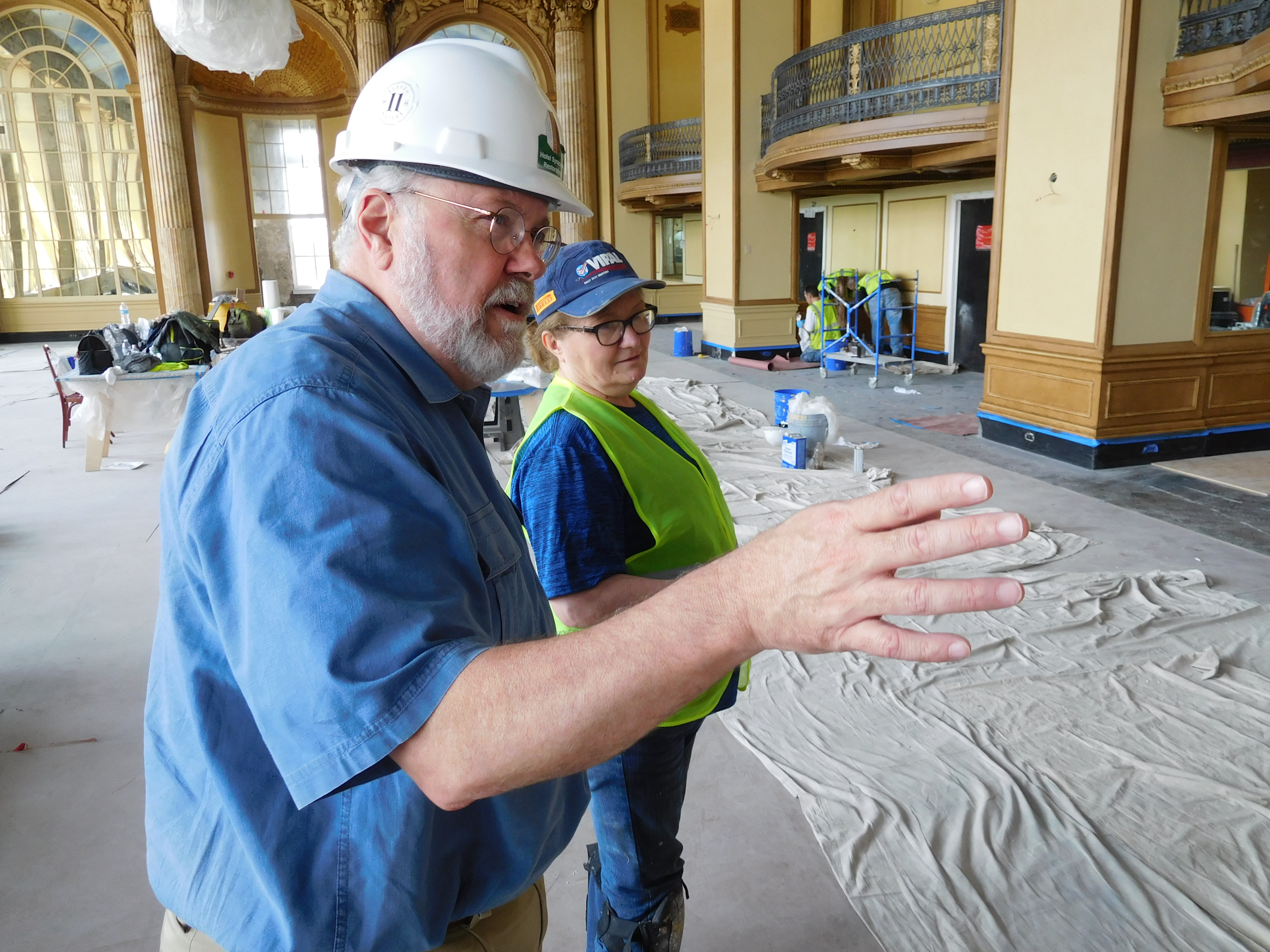 Riley working with a contractor in the Grand Ballroom of the Hotel Syracuse
