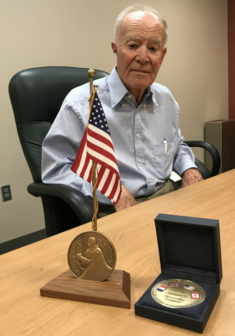 Miller with medals he was awarded for Here Rests In Honored Glory. On the left is the George Washington Honor Medal from the Freedoms Foundation at Valley Forge. On the right is a D-Day Medal from the Normandy Museum in France.