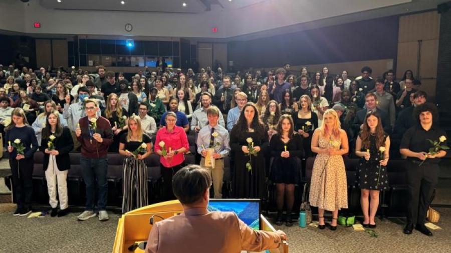 New Phi Theta Kappa Honor Society members are congratulated by Advisor Dr. Annie Tuttle (at podium with back to camera).