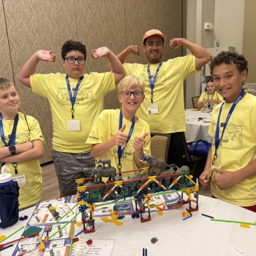 Students celebrated their successful bridge building experience during Micron-sponsored Chip Camp. OCC class of 2024 member Alex Espitia-Casallas (wearing cap) worked with students during the exercise.
