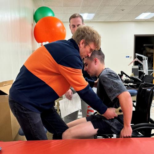 Students in Onondaga Community College's Physical Therapist Assistant program practice the challenging skill of transferring a patient out of a wheelchair in the Physical Therapy lab in Ferrante Hall.