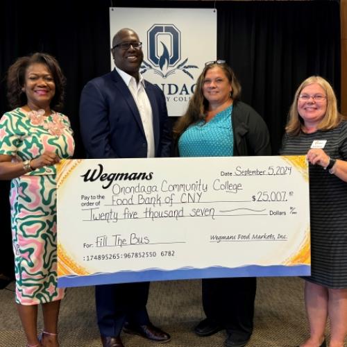 Joining in the check presentation are (left to right) Evelyn Ingram of Wegmans, Warren Hilton and Erika Sheets of OCC, and Karen Belcher of the Food Bank.