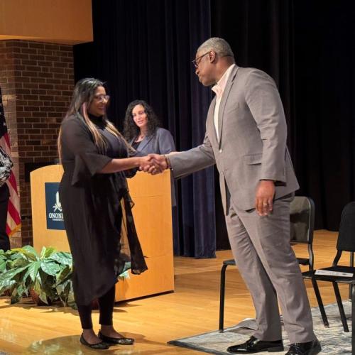 Mirianny Tifa Paulino (left) is welcomed into the Phi Theta Kappa Honor Society by OCC President Dr. Warren Hilton (right).