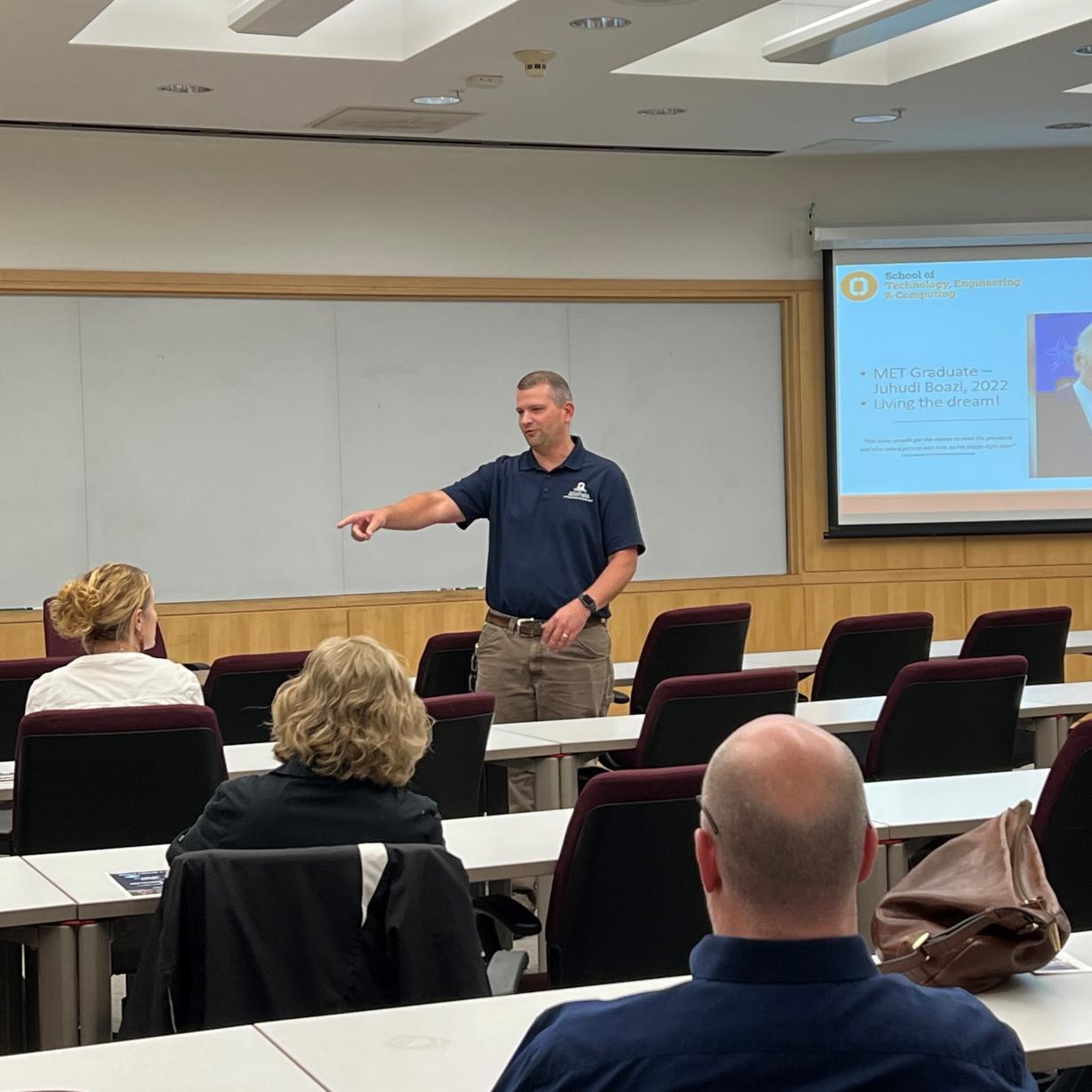 Professor Ryan Beckley speaks with high school teachers and industry representatives in the Whitney Applied Technology Center. Professor Ryan Beckley speaks with high school teachers and industry representatives in the Whitney Applied Technology Center.