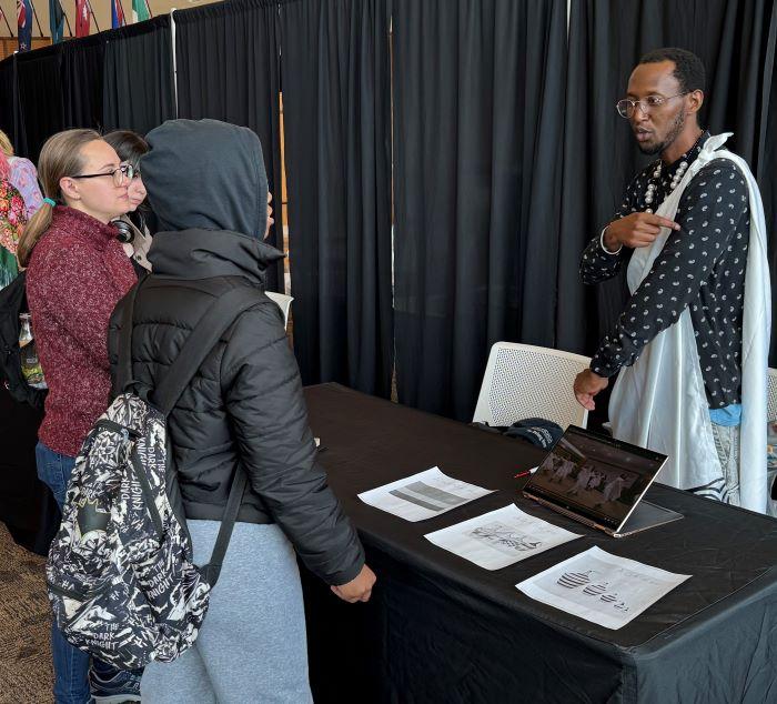 Onondaga Community College student Noel Ponthuit tells fellow students about his native Rwanda at the World Languages & Cultural Fair. Onondaga Community College student Noel Ponthuit tells fellow students about his native Rwanda at the World Languages & Cultural Fair.