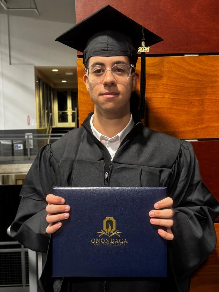 Kyrillos Dawoud is a graduate of Cicero-North Syracuse High School who is completing his Business Administration degree a semester early. He immigrated to the U.S. from Egypt 16 years ago. Both of his parents are also OCC graduates. He's pictured following OCC's Graduation Ceremony Wednesday night. Kyrillos Dawoud is a graduate of Cicero-North Syracuse High School who is completing his Business Administration degree a semester early. He immigrated to the U.S. from Egypt 16 years ago. Both of his parents are also OCC graduates. He's pictured following OCC's Graduation Ceremony Wednesday night.